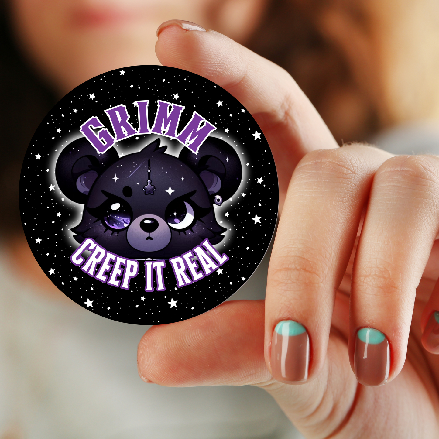 A collection of 1.25-inch and 2.25-inch button pins featuring Grimm with the slogan "Creep it Real" from the Grimm & Friends Goth Collection.