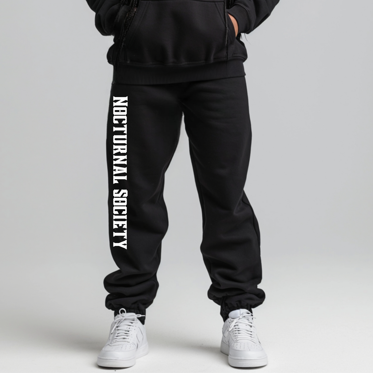 A pair of black sweatpants featuring the "Nocturnal Society" logo, designed to match the Nocturnal Society Goth Club Hoodie from the Grimm & Friends Goth Collection.