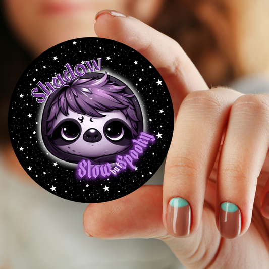 A collection of 1.25-inch and 2.25-inch button pins featuring a goth sloth with the slogan "Slow and Spooky" from the Grimm & Friends Goth Collection